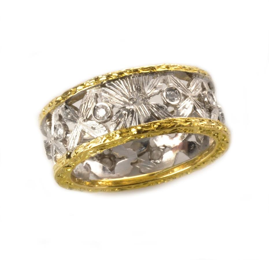 This is a 1970's 18k and diamond Buccellati style Band: This is a 1970's 18k and diamond Buccellati style Band. The ring features a repeated open frame "X" design interspersed with 10 round brilliant cut diamonds that weigh approximately .25cts. They are