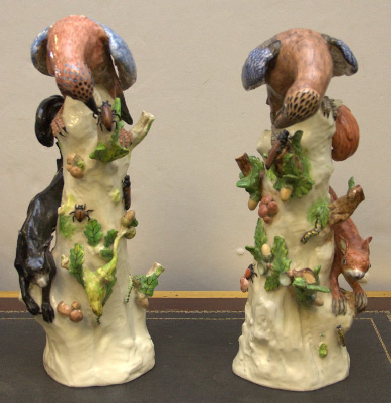 PAIR OF MODELE ROYAL VIENNA PORCELAIN BIRDS SCULPTURES: A pair of Royal Vienne sculptures depicting birds of prey with insects and squirrels. One piece has Royal Vienne Bindenshild mark and the other signed Modele. Each measures approx. 16 1/4" height.