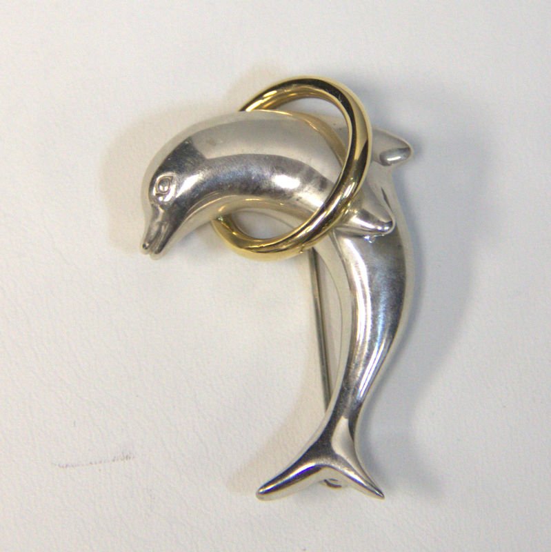 Vintage Tiffany & Co Dolphin Jumping Over 18KT Ring: Vintage Tiffany & Co dolphin jumping over 18 kt yellow gold ring. Measures approx 1 1/2" long x 3/4" wide