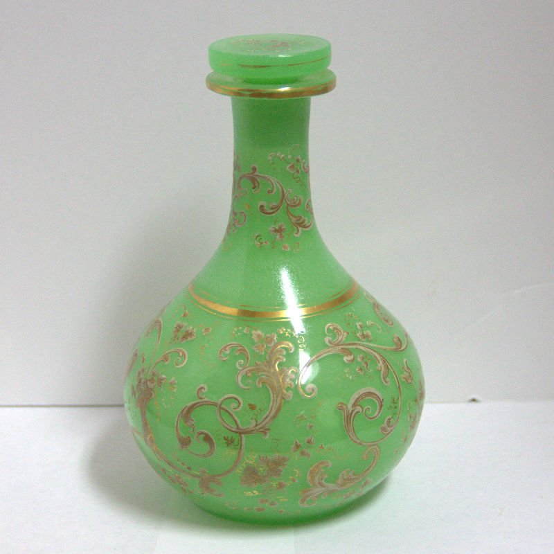 Green Opaline Decorated Decanter: Green opaline decanter with stopper decorated with gilt scrolls throughout measurse 7" h