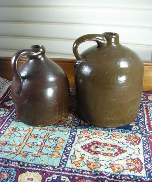 Two Antique Stoneware Jugs in brown glaze. 1 gallon