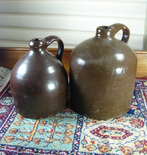 Two Antique Stoneware Jugs in brown glaze. 1 gallon - 2