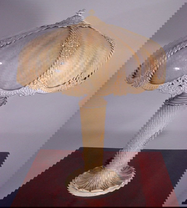 Early electric painted white metal table lamp. 6: Early electric painted white metal table lamp. 6 stoned caramel slag glass panels. 1 cracked and some chips, needs rewiring. 24"high with 18" diameter shade.