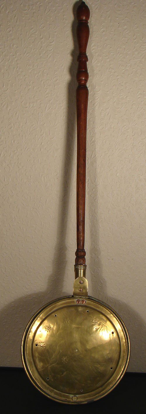 Antique Brass Bed Warmer with Chestnut Wood Handle.: Antique Brass Bed Warmer with Chestnut Wood Handle. Warmer lid is decorated with a bird and flowers below the sun shining through clouds. ca.1820 measures: 4' 3 1/2"l x 12"diam.