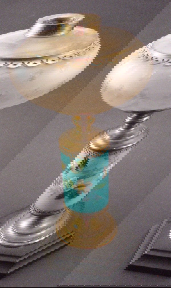 Antique Iron, Brass and Glass Kerosene Parlor Tab: Antique Iron, Brass and Glass Kerosene Parlor Table Lamp. Acid finished font, light blue floral decorated milk glass and brass column. Hexagonal iron base. No burner or chimney. 13" x 5 1/2"