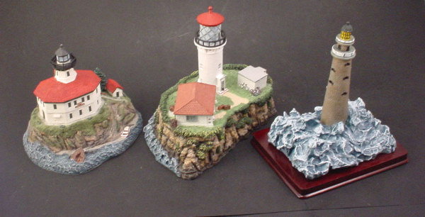3 Cast Resin light house figures.