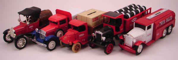 Four Ertl Banks and One Liberty Classics Bank, Tru: Four Ertl Banks and One Liberty Classics Bank, True Value. Including 1930 Diamond 2 1/2ton 2 3/4"h x 8"l x 2 1/2"w, Kenworth truck 3 1/4" x 8 1/4"l x 2 1/2"w, 1926 bull dog, 1918 Ford Model T Runabout