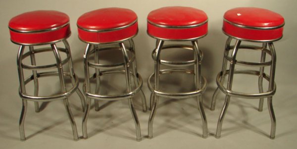 Four Vintage Chrome Swivel Stools. Red naugahyde.