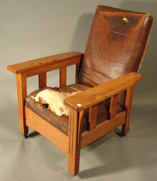 Oak Mission Arm Chair Recliner and slide out foot: Oak Mission Arm Chair Recliner and slide out foot rest. Bronze plaque on back reads "Royal Chair Co. Royal Easy Chair - The Push Button Kind". Appears to have original upholstery in need of restoratio