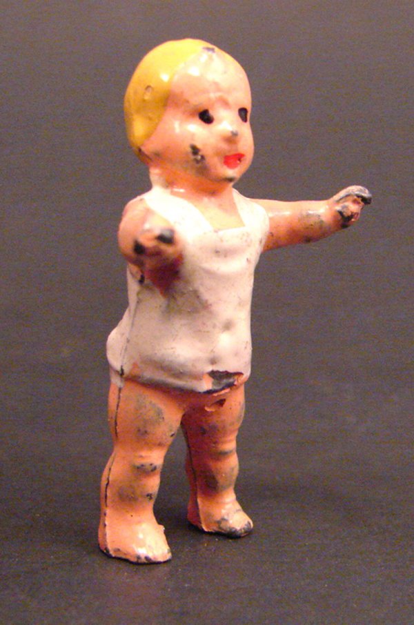 Antique Miniature Painted Lead Figure of Baby in: Antique Miniature Painted Lead Figure of Baby in t-shirt. Losses to paint. 1 1/4"h