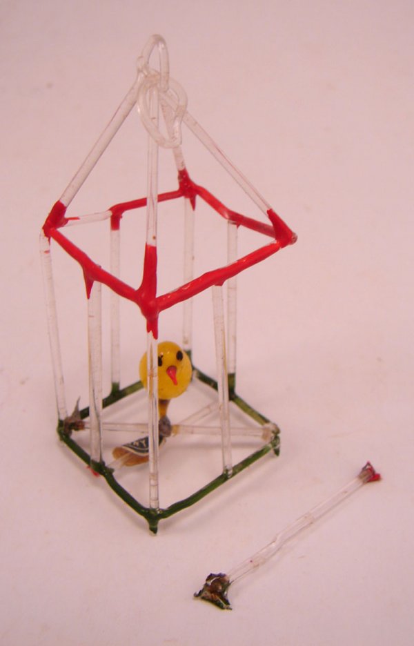 German Antique Glass Christmas Ornament. Bird in: German Antique Glass Christmas Ornament. Bird in cage. Some wear to finish. One glass bar not attached. 2 3/4"h x 1 1/4" x 1"