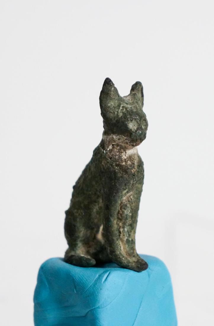 ANCIENT EGYPTIAN BRONZE CAT: Late Dynastic probably 712-343 B.C. A solid bronze cast with a tenon below the rear legs, seated with ears erect and its tail curled around the right side. Bronze cats. Ex Harlan J .Berk Auction. heig