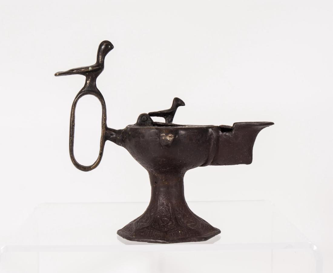 LARGE ISLAMIC SELJUK BRONZE OIL LAMP ,CIRCA: 12TH: LARGE ISLAMIC SELJUK BRONZE OIL LAMP ,CIRCA: 12TH CENTURY AD TO 13TH CENTURY AD, ENGRAVED DECORATION AND ARABIC SCRIPT CALLIGRAPHY Height: 5.25in, Length: 5.75in.