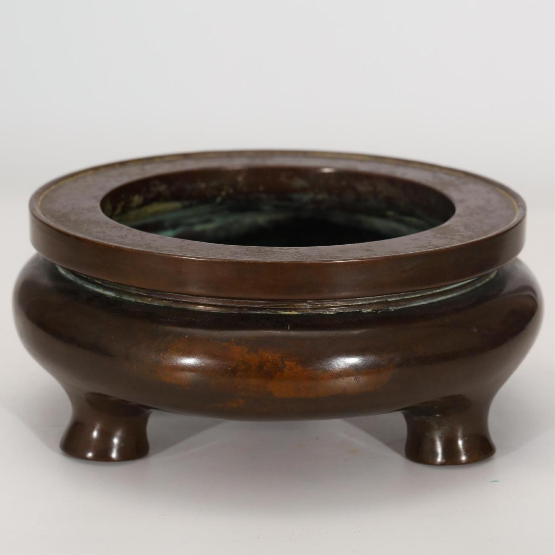 CHINESE BRONZE TRIPOD CENSER: Ming Dynasty; Diameter: 6.2 inches. Height: 2.6 inches. Diameter: 15.8cm Height: 6.7cm Weight: 1945g; Condition: Good condition overall.