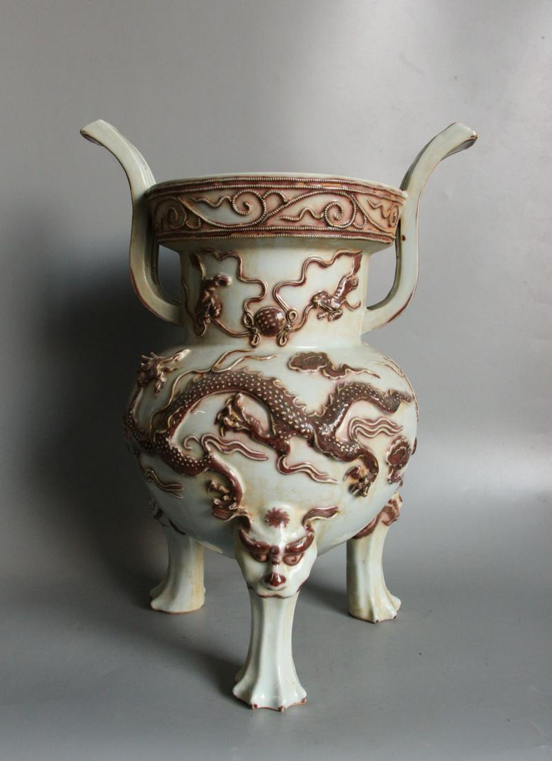 PORCELAIN DRAGON TRIPOD CENSER: Mouth diameter: 7.5 inches. Height: 13.8 inches. Mouth diameter: 19cm Height: 35cm Provenance: From the collections of Mr. Ross from New York.