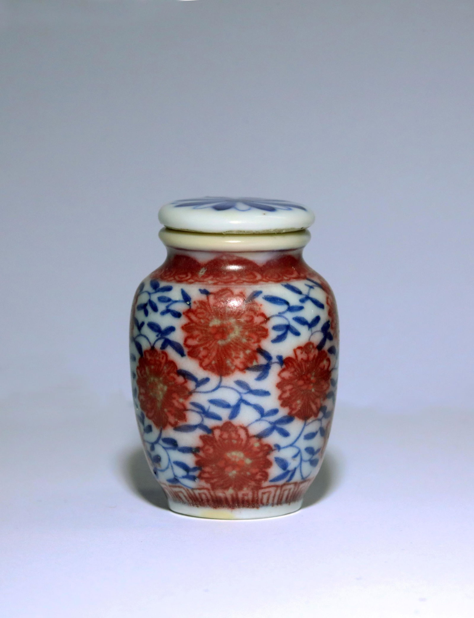 Qing Dynasty Blue White Iron Red Snuff Bottle: Qing Dynasty Blue White Iron Red Snuff Bottle. Height: 1.7 inches. Total Height: 1.9 inches. Diameter: 1.3 inches. Height: 4.4cm Total Height: 4.8cm Diameter: 3.2cm. Provenance: Florida, Mrs. Mary Ann