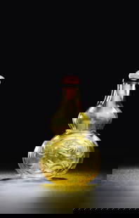 A Carved Glass Double-Gourd-Form Snuff Bottle: 1750-1850 The transparent yellow bottle is carved on the lower gourd with two chi-dragon roundels. 2 ½ in. (6.4 cm.) high, quartz stopper. Christie's 14 sep 2016 THE RUTH AND CARL BARRON COLLEC