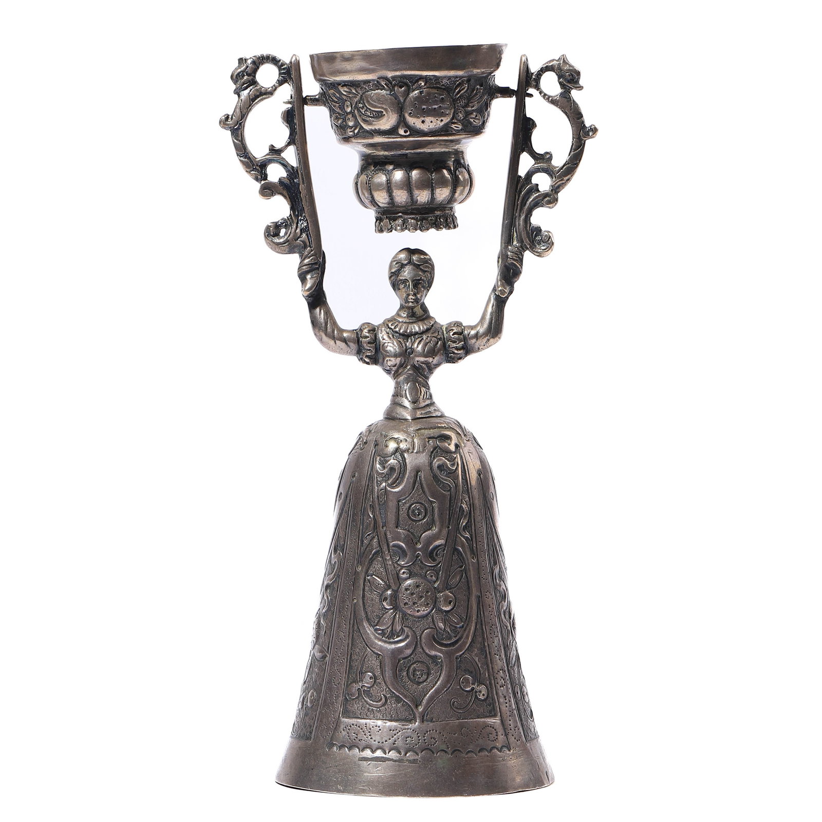 A SILVER FIGURAL GOBLET IN THE FORM OF A WOMAN: height: 6 1/2 in (16.5 cm); weight: 160 g This silver goblet features an intricately detailed figural design of a woman dressed in ornate period attire. The stem is formed by the upper body of the wom