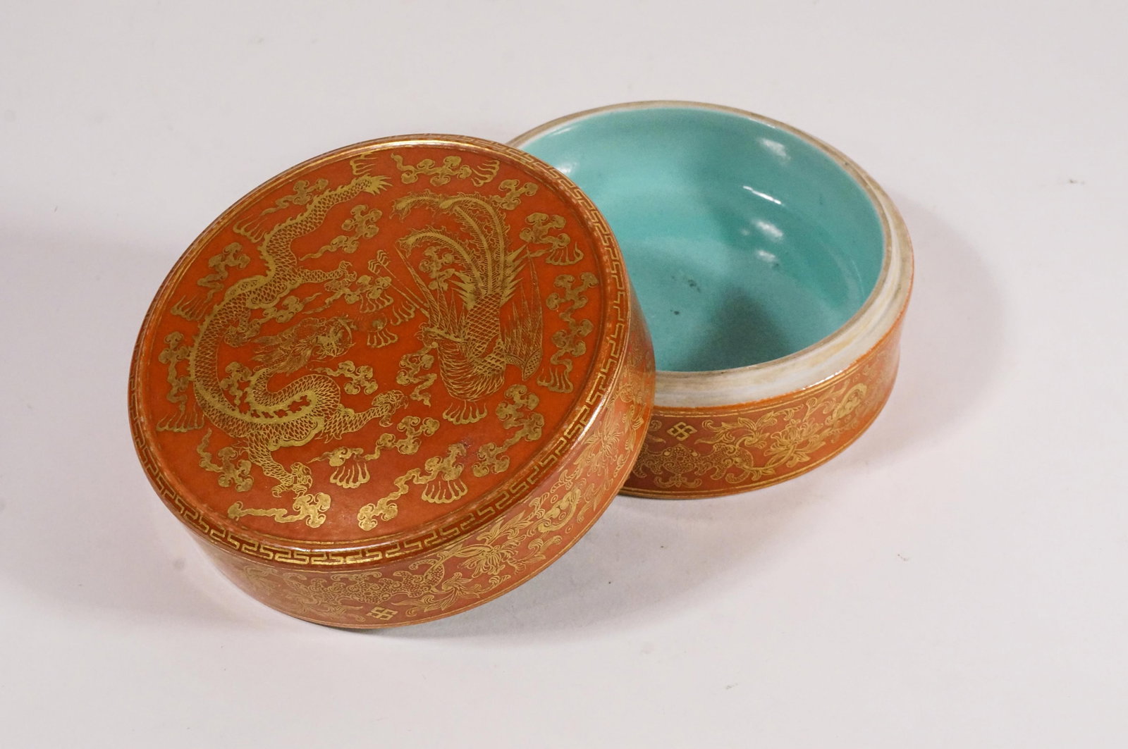 Chinese Turquoise And Coral Glazed Cover Box: Dragon And Phoenix Motif In Gilt Drawings With Mark On Bottom. Height: 2.2in, Diameter: 4in.