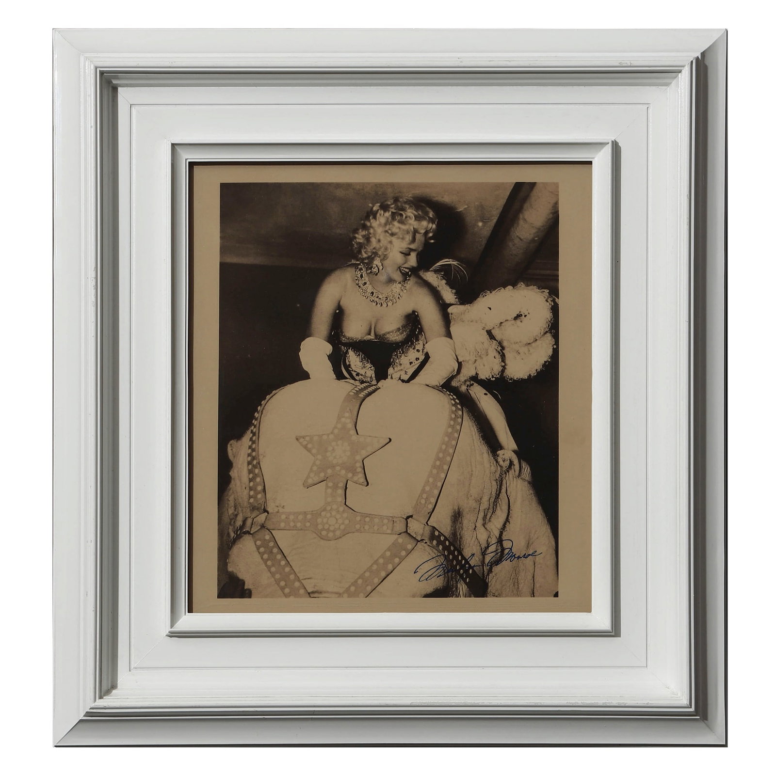 WEEGEE (ARTHUR FELIG) (1899-1968) Marilyn Monroe, circa 1955: Description Title: Marilyn Monroe on Circus Elephant Period: Circa 1955 Materials: Gelatin silver print by Weegee, inscribed "Marilyn Monroe" in blue ink on the recto Size: Photograph 9 1/4 x 7 7/16 i