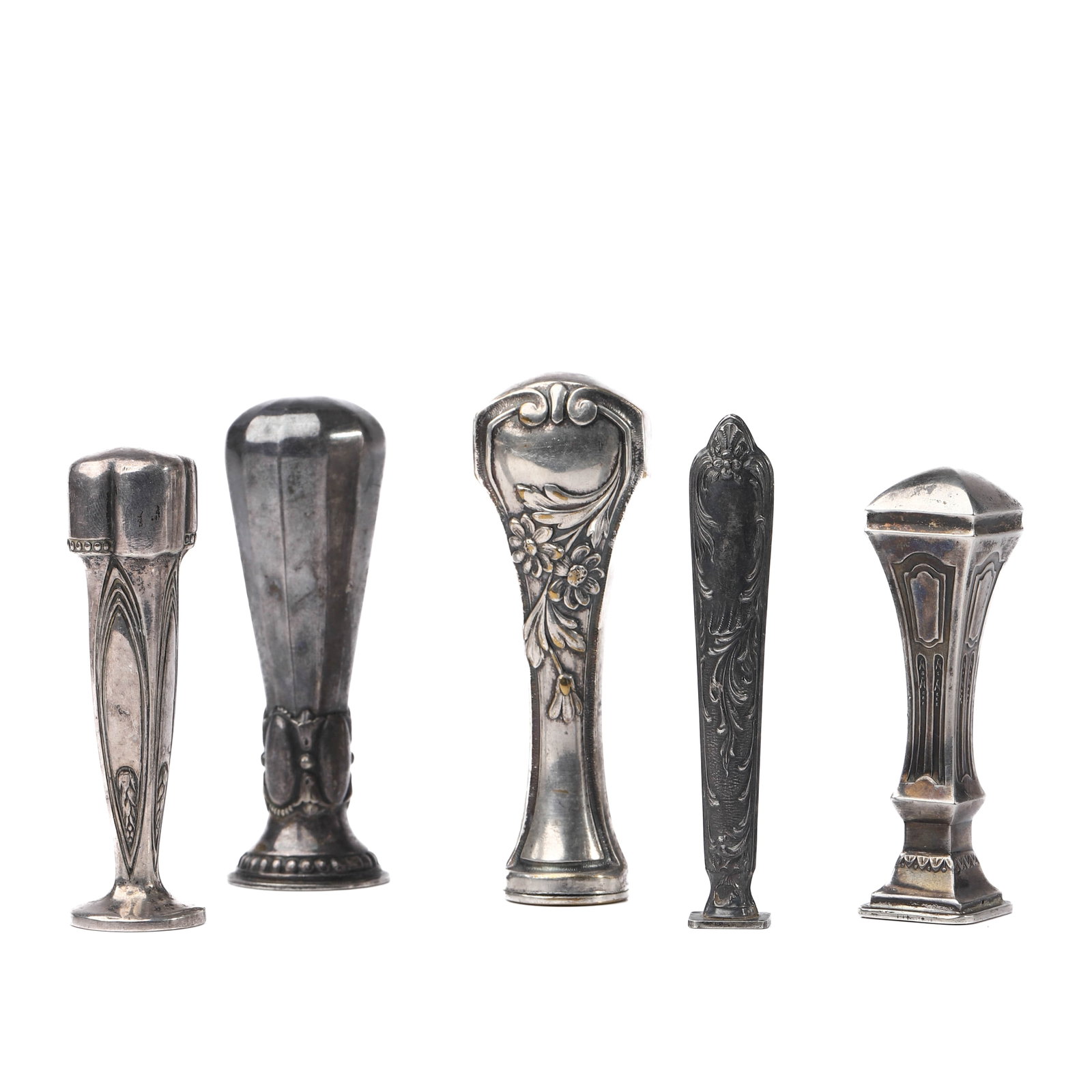 A SET OF FIVE ANTIQUE SILVER-TONED WAX SEAL STAMPS: Dimensions tallest 3 5/8 in (9.2 cm); smallest 3 1/32 in (7.7 cm); total weight approx. 125.6 g Description This assembled group comprises five antique silver-toned wax seal stamps, each with distinct