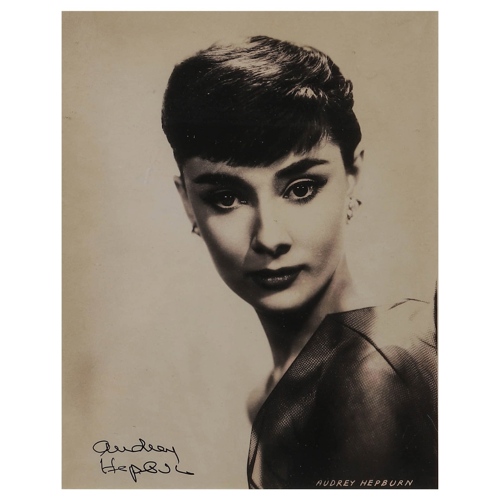 PORTRAIT OF AUDREY HEPBURN, CIRCA 1950S, AUDREY HEPBURN: Portrait of Audrey Hepburn, circa 1950s Gelatin silver print, signed "Audrey Hepburn" in ink (lower left) Dimensions: Image 7 13/16 x 9 7/8 in. (19.9 x 25.1 cm); Frame 13 x 17 1/2 in. (33 x 44.5 cm) D