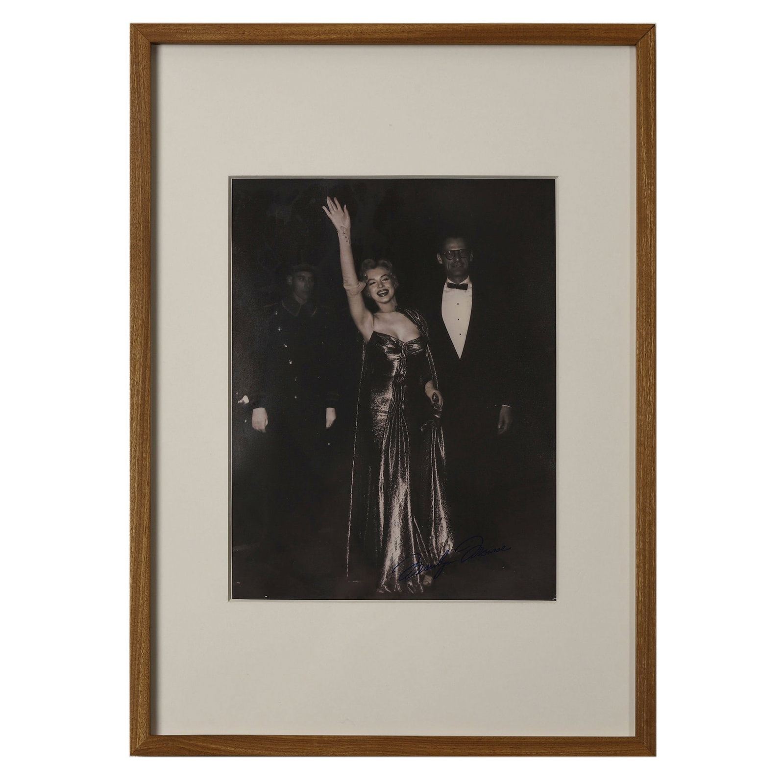 MARILYN MONROE AT THE PREMIERE OF "THE SEVEN YEAR ITCH," 1955: Marilyn Monroe at the Premiere of "The Seven Year Itch," 1955 Gelatin silver print Dimensions: Image 7 5/8 x 9 7/8 in. (19.3 x 25.1 cm); Frame 12 3/8 x 17 1/4 in. (31.5 x 43.8 cm) Signed "Marilyn