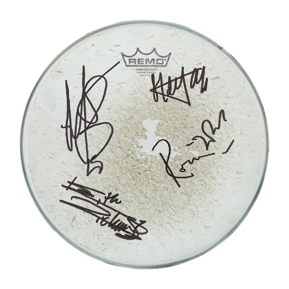 THE ROLLING STONES FULLY SIGNED REMO DRUMHEAD: Diameter 12 1/4 in (31 cm) This Remo drumhead has been fully signed by four members of The Rolling Stones, one of the most influential rock bands in music history. The signatures are executed in