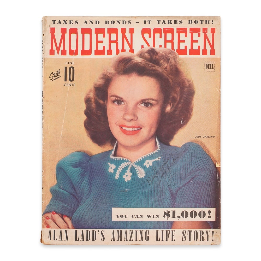 JUDY GARLAND SIGNED ENTIRE MAGAZINE - MODERN SCREEN: 11 1/4 x 8 1/2 in (28.7 x 21.5 cm) Provenance and Authentication: According to the Letter of Authenticity (LOA) and Certificate of Authenticity (COA) provided by the consignor, this collectible was su