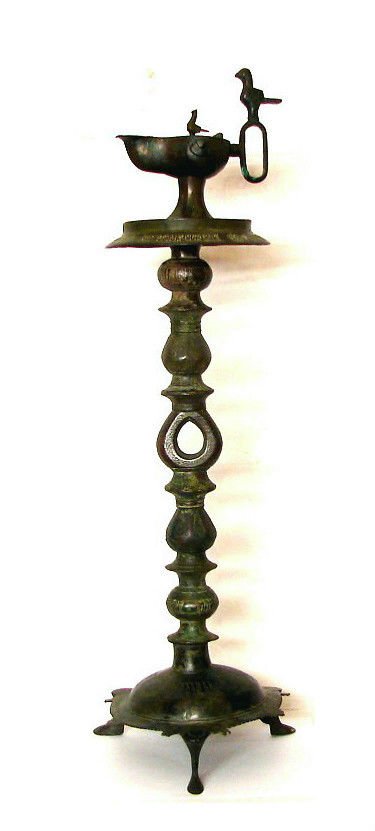 ANTIQUE ISLAMIC SELJUK BRONZE OIL LAMP STAND: Antique Islamic Seljuk Bronze Oil Lamp Stand , Circa: 12th Century AD to 13th Century AD, engraved decoration and Arabic script calligraphy. Size : 69 cm with lamp x 20 cm