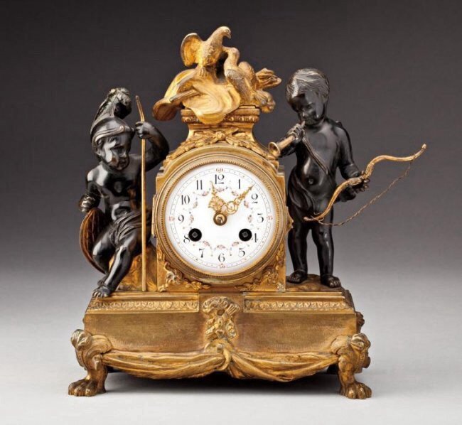 19TH CENTURY GILT AND PATINATED CLOCK: 10.5" High. Estimate $1.000-1.200