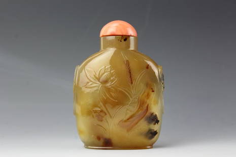 Chinesepale agate snuff bottle with coral stopper 19th: Chinesepale agate snuff bottle with coral stopper. Low relief carved lotus with mandarin ducks and crane. 19th centuryH:3.5 W:2 inches