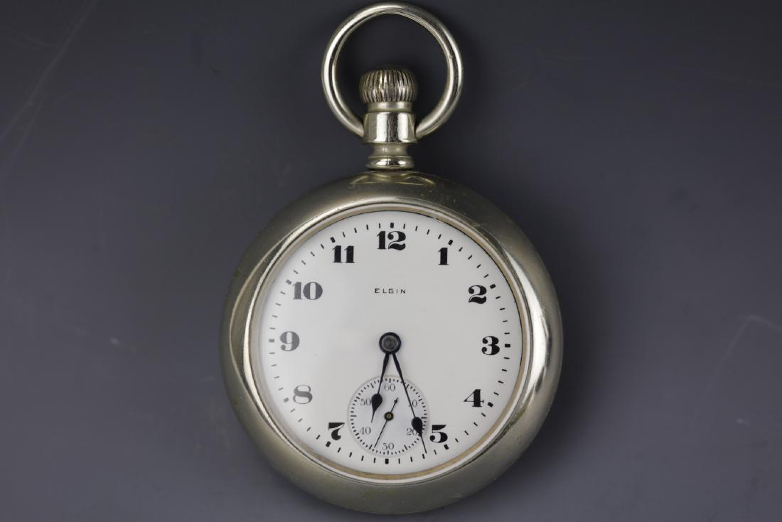 Vintage Elgin Silver pocket with white dial and Arabic: Vintage Elgin coin Silver pocket with white dial and Arabic numerals. Good movements. D: 2.25 inches