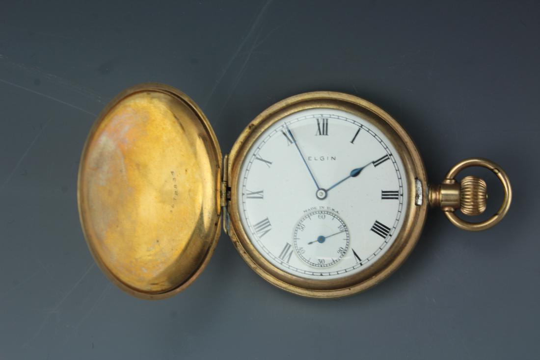 Vintage Elgin gilt hunter pocket watch with white dial: Vintage Elgin gilt hunter pocket watch with ceramic white dial and blue hands. No movements D: 2 inches