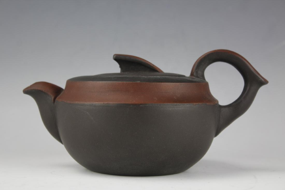 A Zisha Pottery Teapot by Wang Nan Lin: H: 3.25 W: 8 D: 4.725 Inches