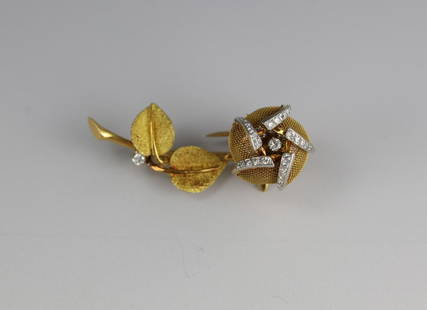 A 18 KT Gold Flower with Leaves Diamonds Brooch French: A 18 KT Gold Flower with Leaves Diamonds Brooch French H:1 3/4 inches/4.5 cm weight 12gThere is one diamond which is about 3 mm diameter at the leaves near the stern.At each outside diamond group on t