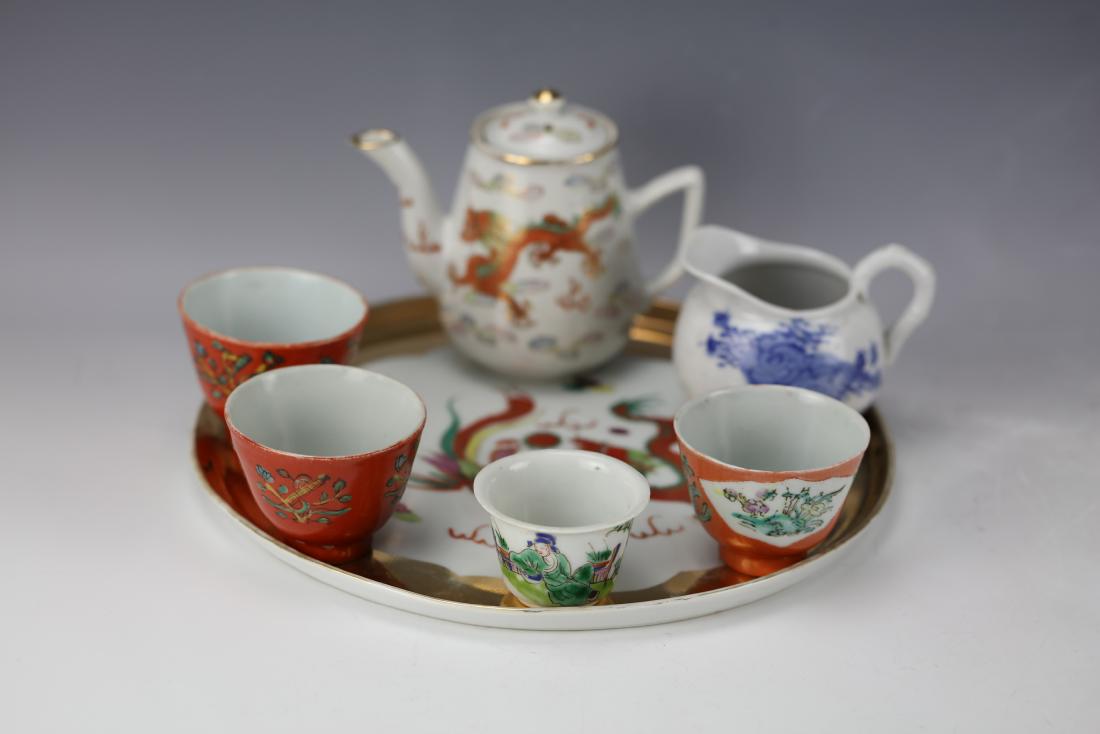 A Group of 8 Famille Rose Clay Teapot Cups and Tray: A Group of Eight Chinese Porcelain Pieces Comprising a Gilt Famille Rose Dragon and Phoenix Tray. A Dragond and Phoenix Teapot. A Blue and White Creamer. Three Iron Red Cups. A Wucai Cup. Tray D: 10 i