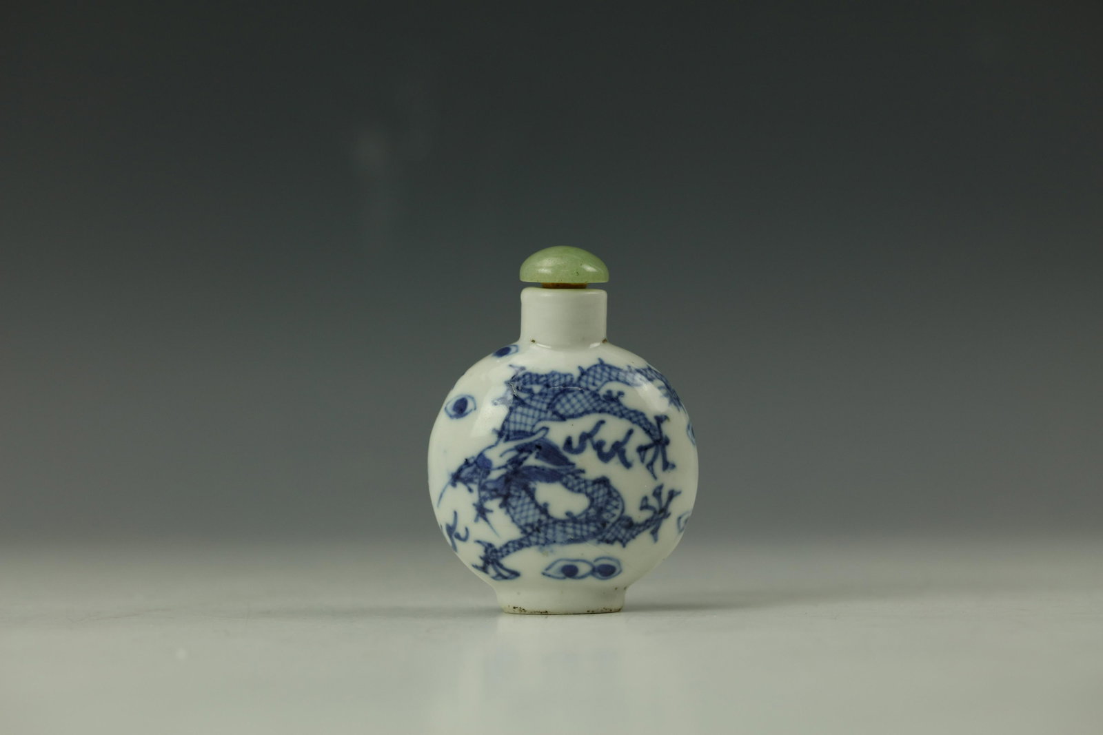 A DRAGON Moonflask Blue and White Snuffle Bottle with: A DRAGON Moonflask Blue and White Snuffle Bottle with Qianlong Mark H: 3 in. (7.62 cm) W: 2.5 (6.35 cm)