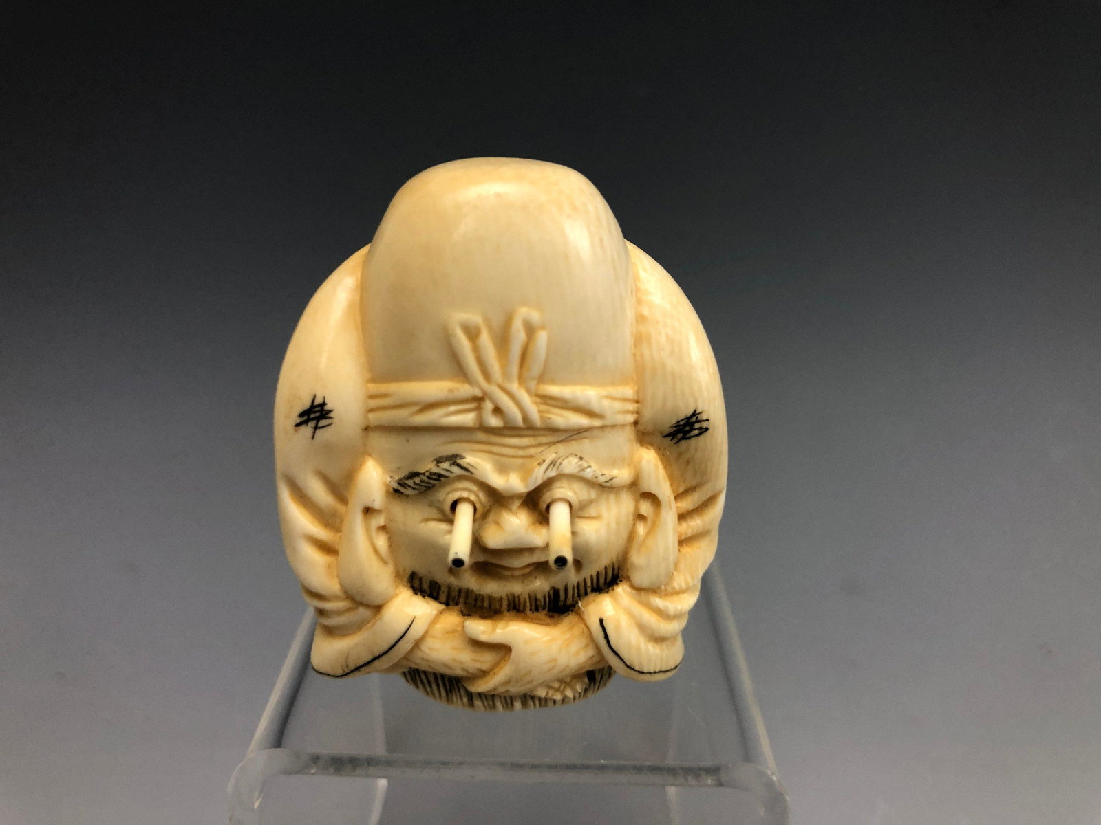 A Cattle Bone Carved Netsuke of EYE POPPING Man: A Cattle Bone Carved Netsuke of EYE POPPING Man H: 1.15 in. (2.92 cm) W: 1.75 in. (4.45 cm)