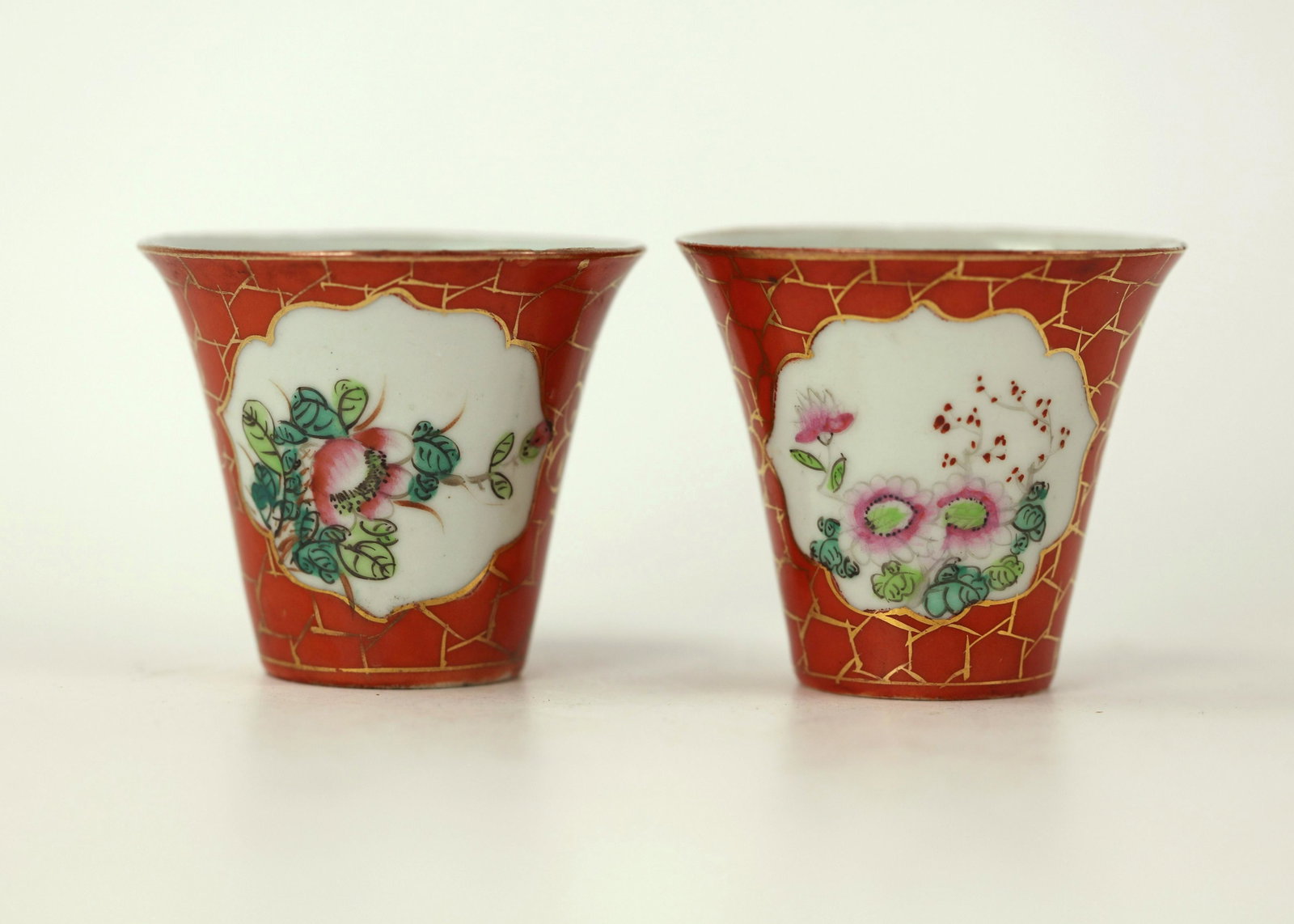 Pair of Chinese Signed Teacups with Red Glaze and Gold: Pair of Chinese Signed Wine or Teacups with Red Glaze and Gold Hexagon Cell Pattern. H: 2.5 in. (6.3 cm) W: 2.8 in. (7.2 cm)