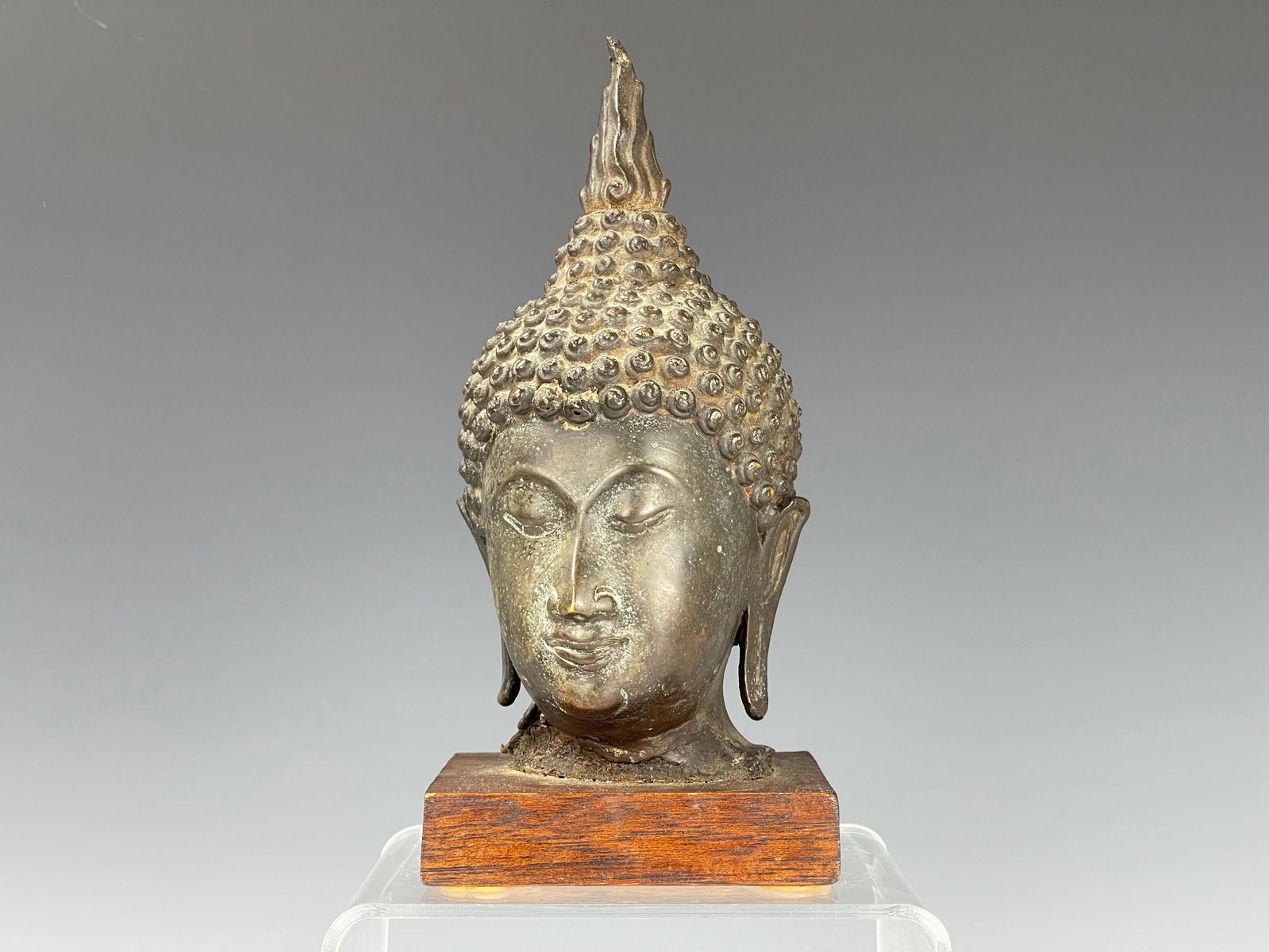 A South Asian Bronze Buddha Head: A South Asian Bronze Buddha Head, H 8 in.(20 cm) including base,preview from Jan.21st to 25th at 2:00 PM TO 6:00 PM Eastern Time Location: 15229 Display Court Rockville MD 20850.