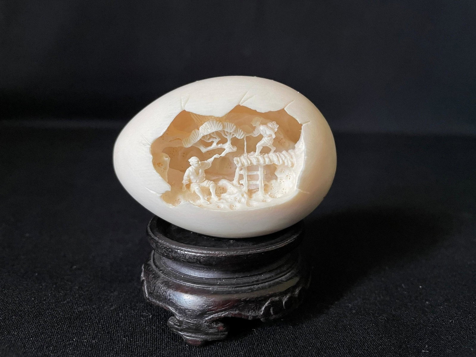 A Carved Cattle Bone Netsuke of Figural Landscape: A Carved Cattle Bone Netsuke of Figural Landscape. H: 1.75 in. W: 2.5 in. D: 1.75 in