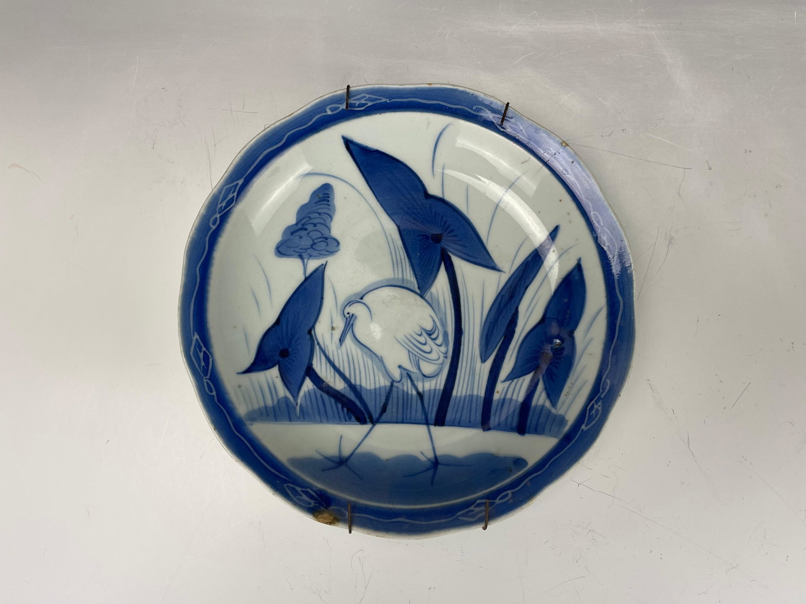 A Blue White Porcelain Plate Lotus and Heron: A Blue White Porcelain Plate Lotus and Heron, H 23 cm(9 in.),Preview from Apr. 17th to 21st from 1:00 PM TO 5:00 PM Eastern Time, Location: 15229 Display Court, Rockville MD 20850.