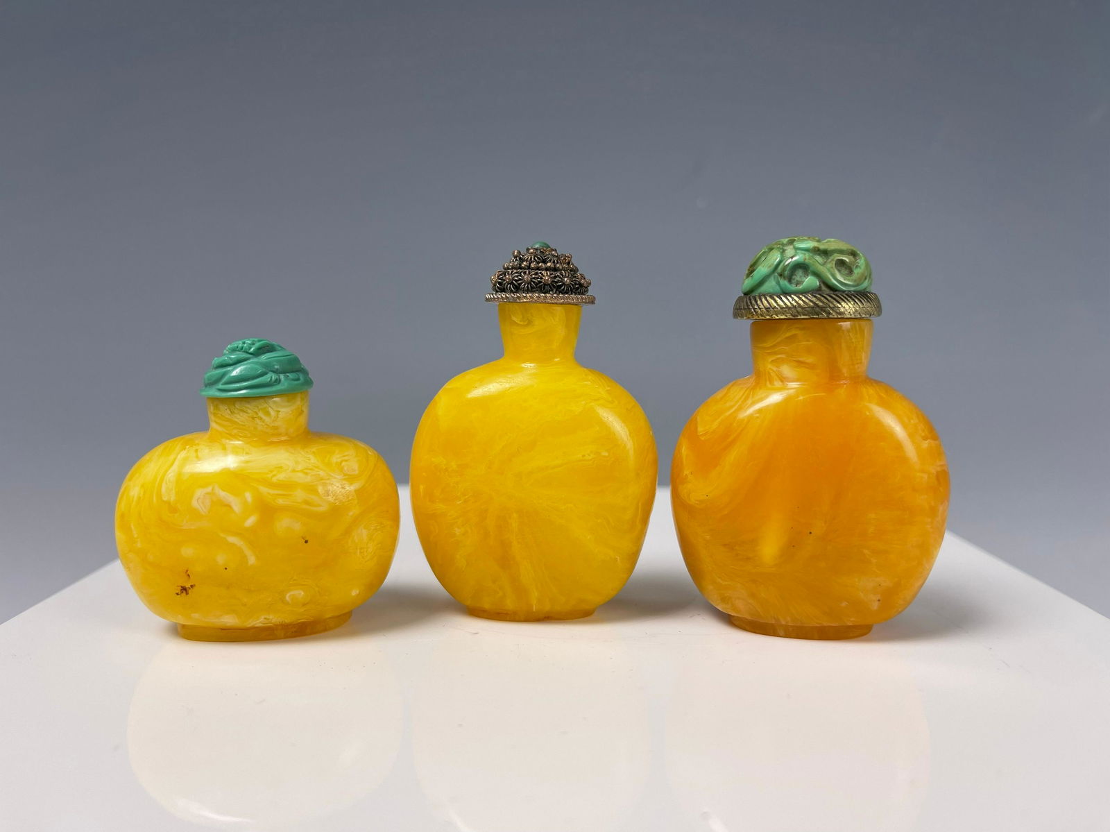 Three Reconstituted Amber Snuff Bottles (1 of 4)
