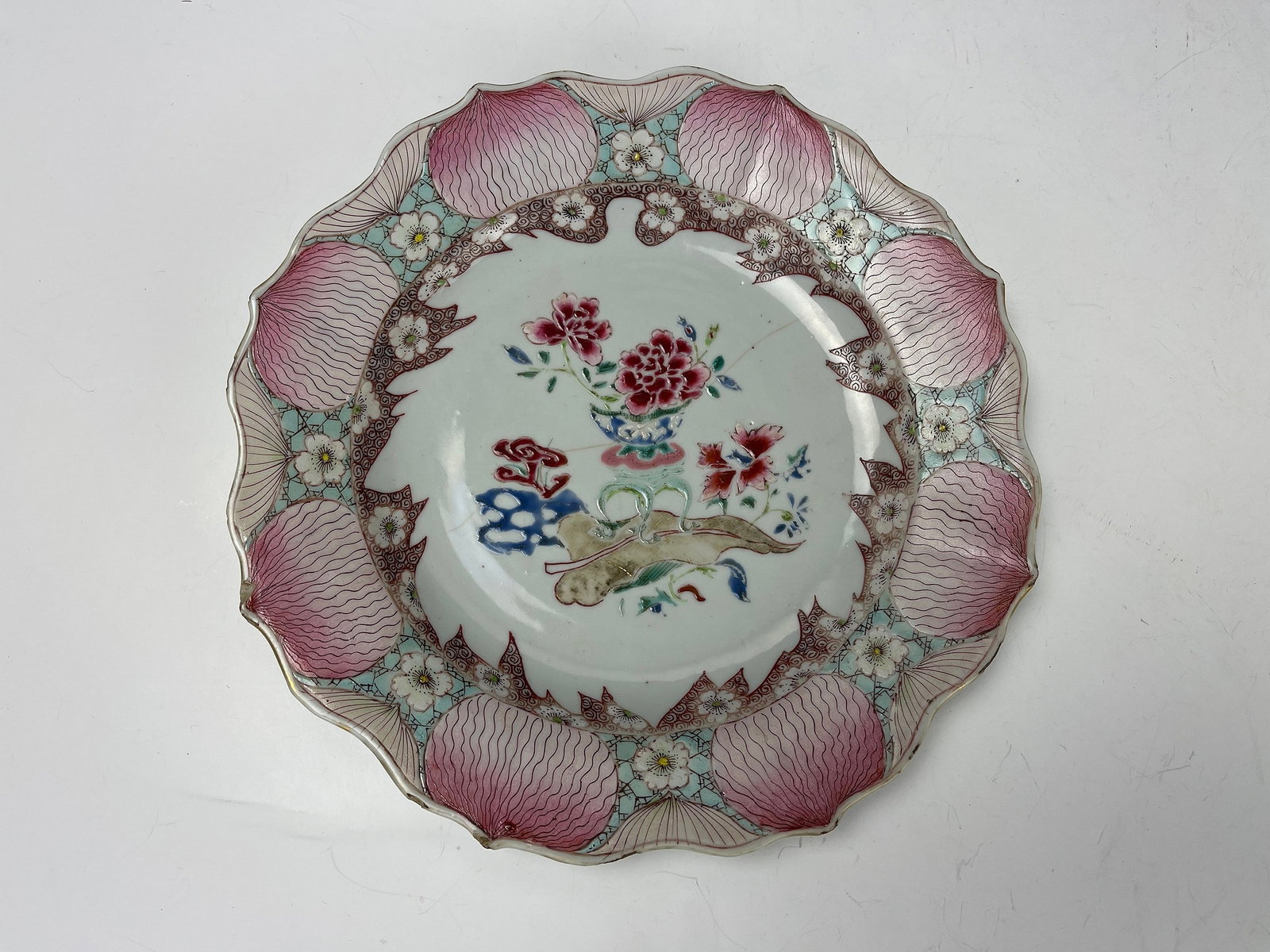 A Chinese Famille Rose Porcelain Lotus Shaped Plate: A Chinese Famille Rose Porcelain Lotus Shaped Plate, with Hairline Cracks, D 22.3 cm(8.8 in.),Preview from Oct. 2nd to 6th from 1:00 PM TO 5:00 PM Eastern Time, Location: 15229 Display Court, Rockvill