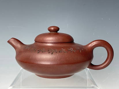 Yixing Zisha teapot incised with calligraphy: Yixing Zisha teapot incised with calligraphy. Marked,W 18 cm(7.3 in.) x H 7.8 cm (3 in.) x D 12 cm (5 in.), Preview from Feb.19th to 23rd from 1:00 PM TO 5:00 PM Eastern Time, Location: 15229 Display