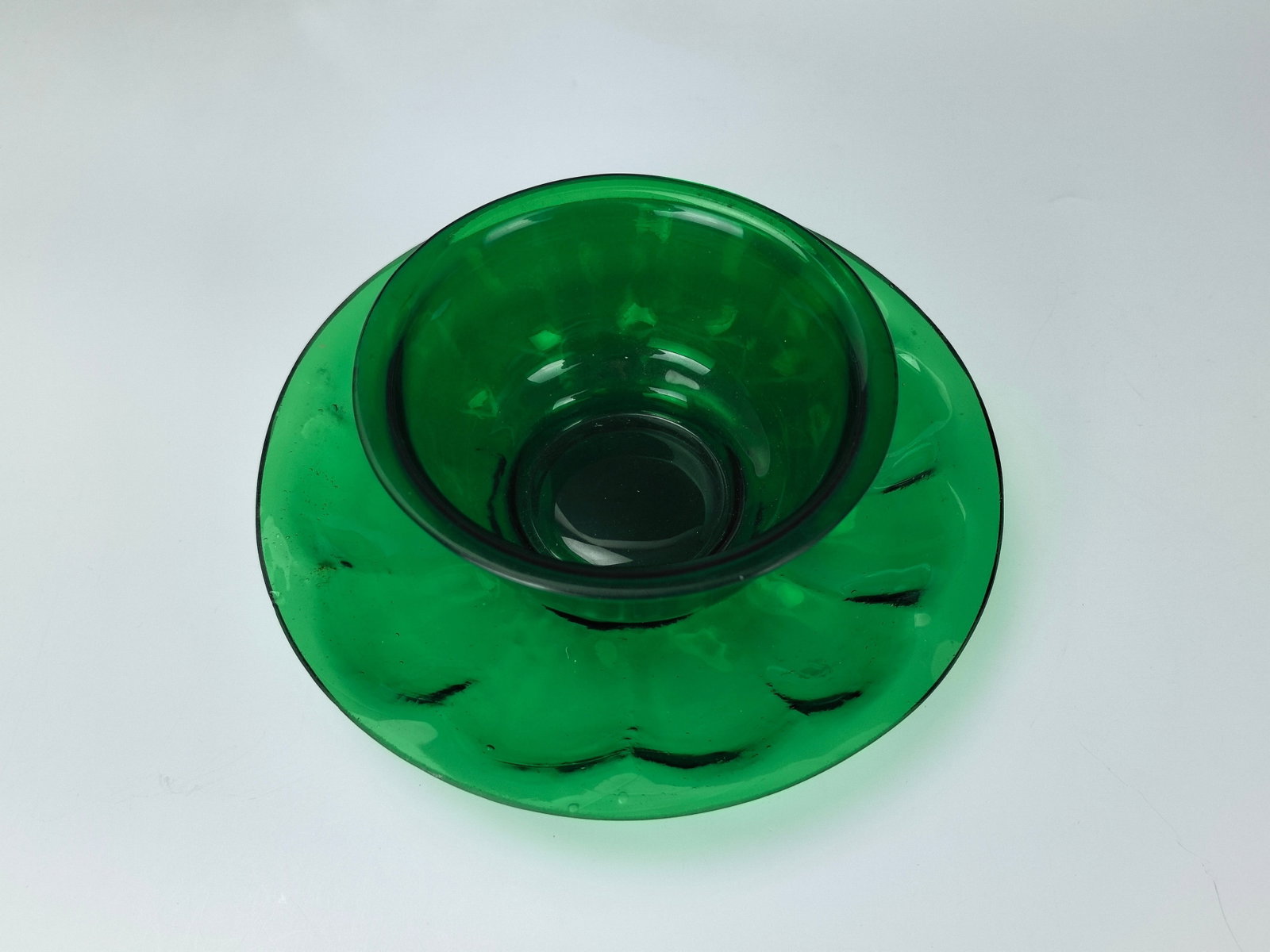 A Set of Peking Glass Green Bowl and Saucer: A Set of Peking Glass Green Bowl and Saucer,Saucer D 16.5 cm ( 6.5 in.) and bowl D 11 cm(4.5 in.), Preview from Apr. 22nd to 26th from 1:00 PM TO 5:00 PM Eastern Time, Location: 15229 Display Court, R