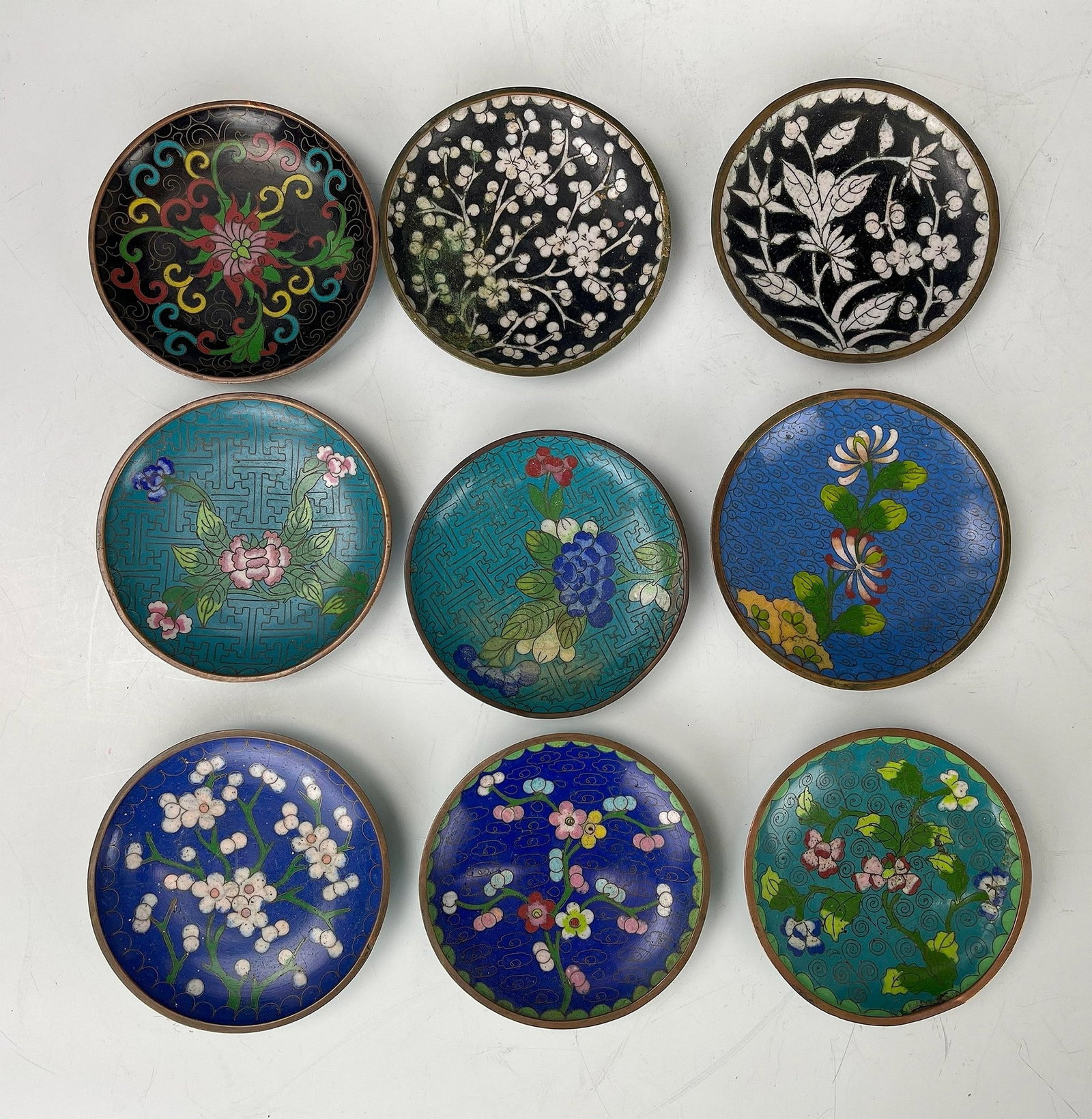 Group of 9 Antique Early 20th Century Cloisonne Coasters: Group of 9 Antique Early 20th Century Cloisonne Coasters, D 9 cm (3.5 in.) x 9, Preview from May 27th to 31st from 1:00 PM TO 5:00 PM Eastern Time, Location: 15229 Display Court, Rockville MD 20850.
