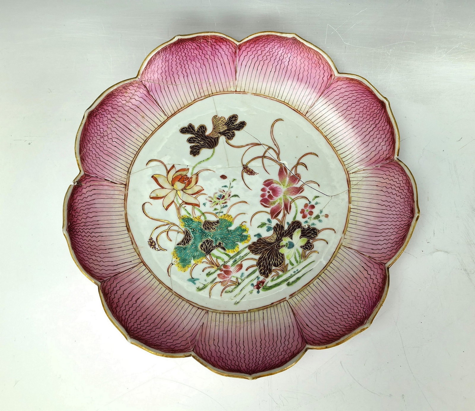 A Chinese Famille Verte Lotus Shaped Plate: A Chinese Famille Verte Lotus Shaped Plate,repaired, Diam25cm. Preview from Jun. 24th to 28th from 1:00 PM TO 5:00 PM Eastern Time, Location: 15229 Display Court, Rockville MD 20850.