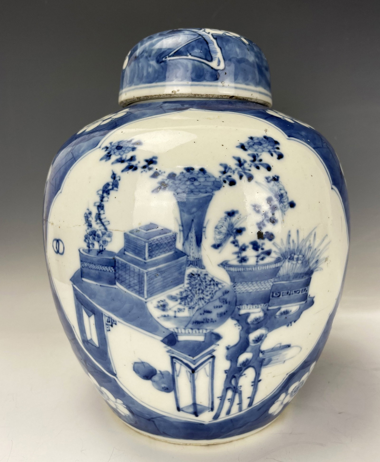 Chinese Blue and White Porcelain Jar with lid Kangxi Mark: Chinese Blue and White Porcelain Jar painted with ice crackle and plum blossoms and antiques, with a reticulated lid, Kangxi mark. H 27 cm (10.6 in.). Preview from Aug. 26th to 30th from 1:00 PM TO 5: